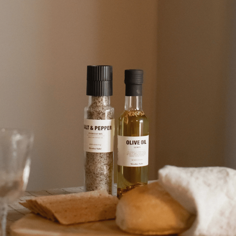 Nicolas Vahé salt & pepper blend and olive oil on a dining table