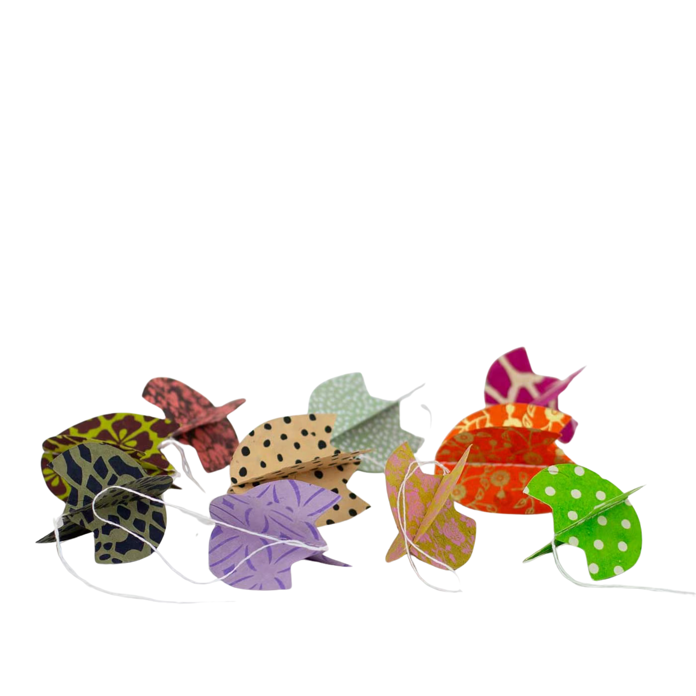 The Tulip Easter Ornaments in Paper, Set of 10 by A World of Craft features colorful leaves with polka dots, animal prints, and florals strung on white string—perfect for charming Easter decorations.