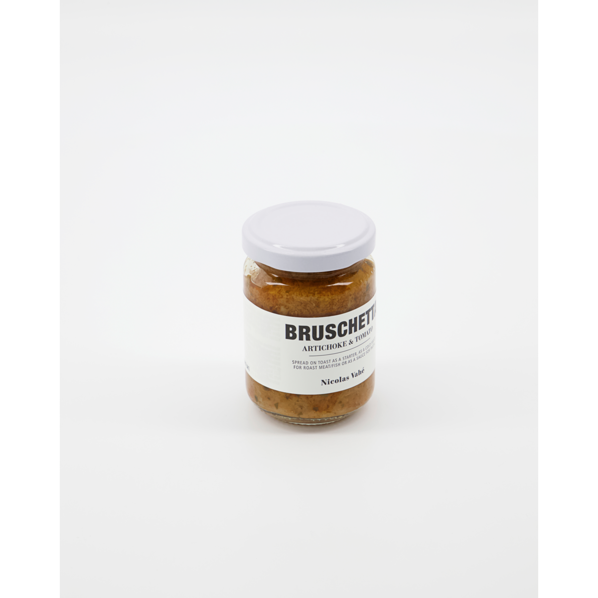 A glass jar of Nicolas Vahé Bruschetta, Artichoke & Tomato, sealed with a white lid and shown on a plain white background—ideal as a savory bruschetta topping or pasta sauce.