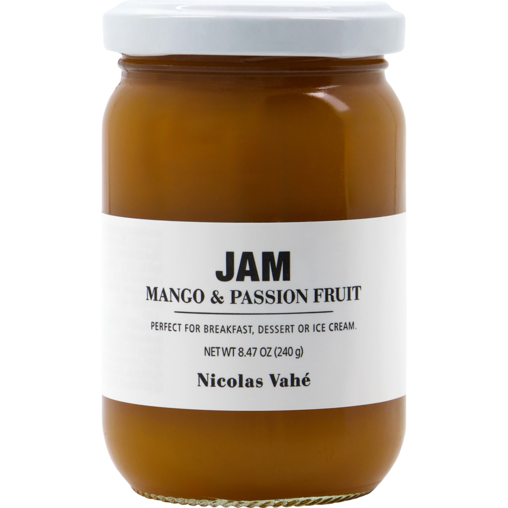 A glass jar of Nicolas Vahé Jam, Mango & Passion Fruit sits elegantly, its white label presenting the flavor, weight, and the distinguished brand name. This irresistible fruit jam combines sweet mango with tangy passion fruit for a perfectly balanced treat.