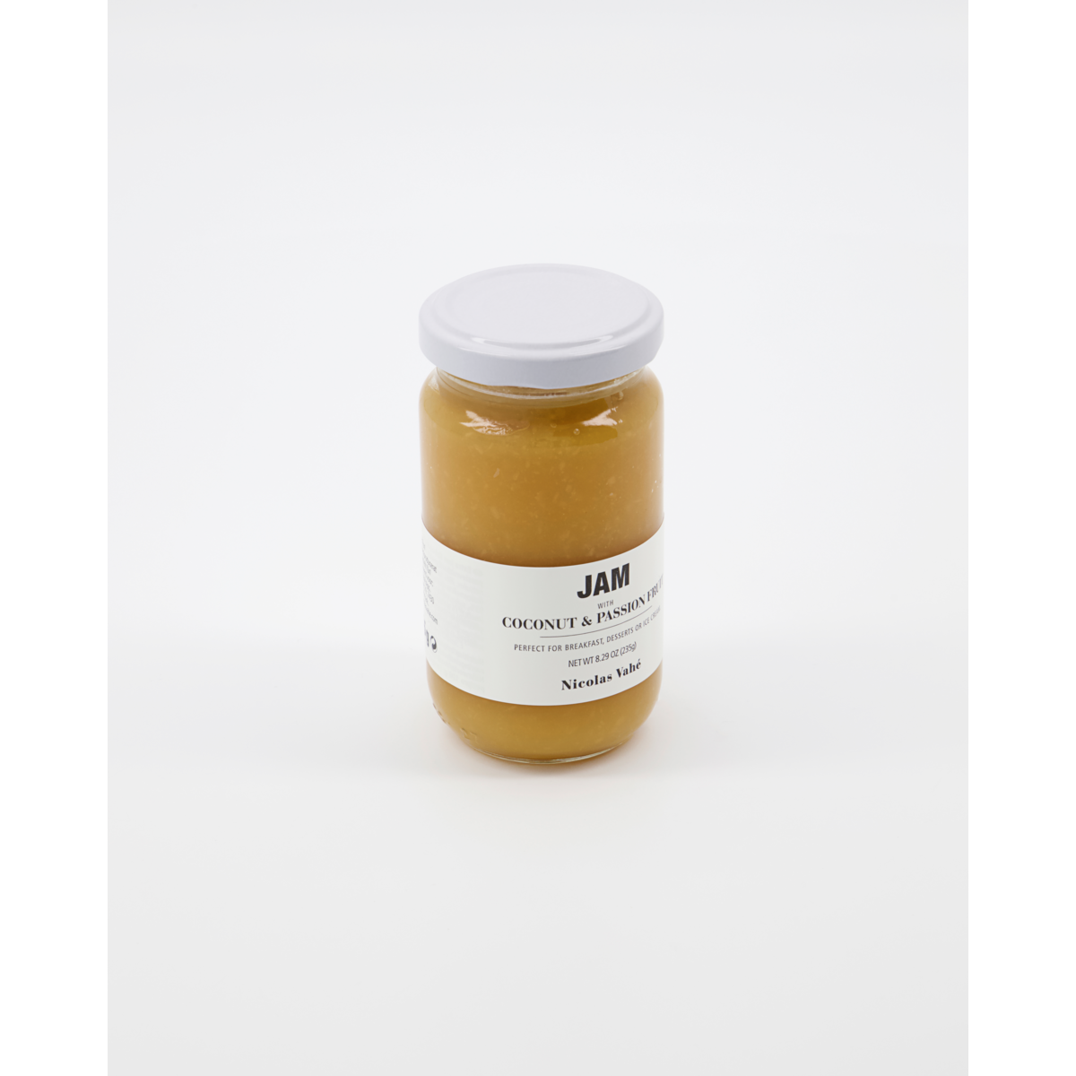A glass jar of Nicolas Vahé Jam, Coconut & Passion fruit, featuring a white label and lid, is displayed on a plain white background.