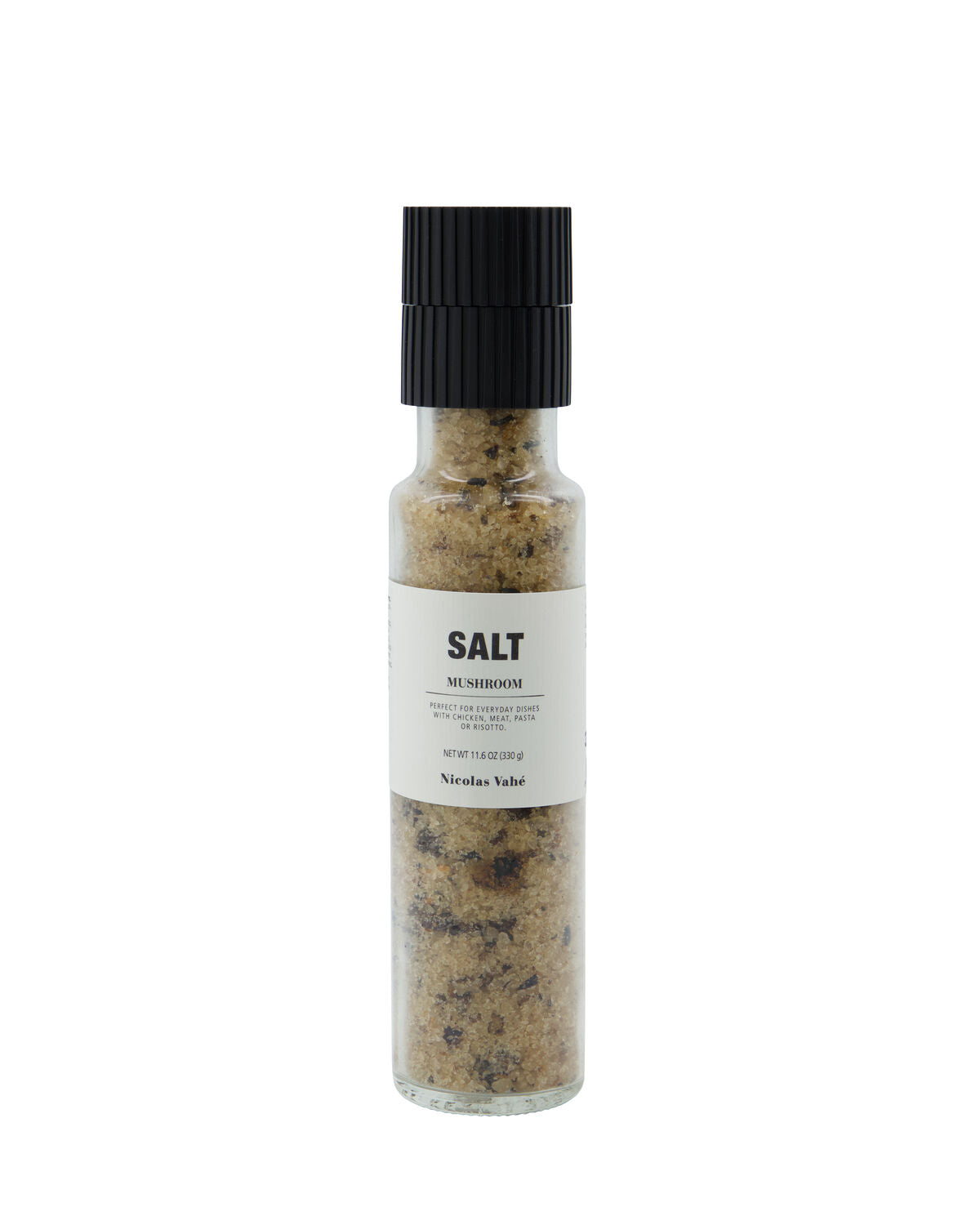 A clear glass grinder filled with Salt, Mushroom from Nicolas Vahé, featuring a sturdy black ceramic grinder top and a white label displaying “Salt, Mushroom” along with product details; inspired by the culinary expertise of Nicolas Vahé.