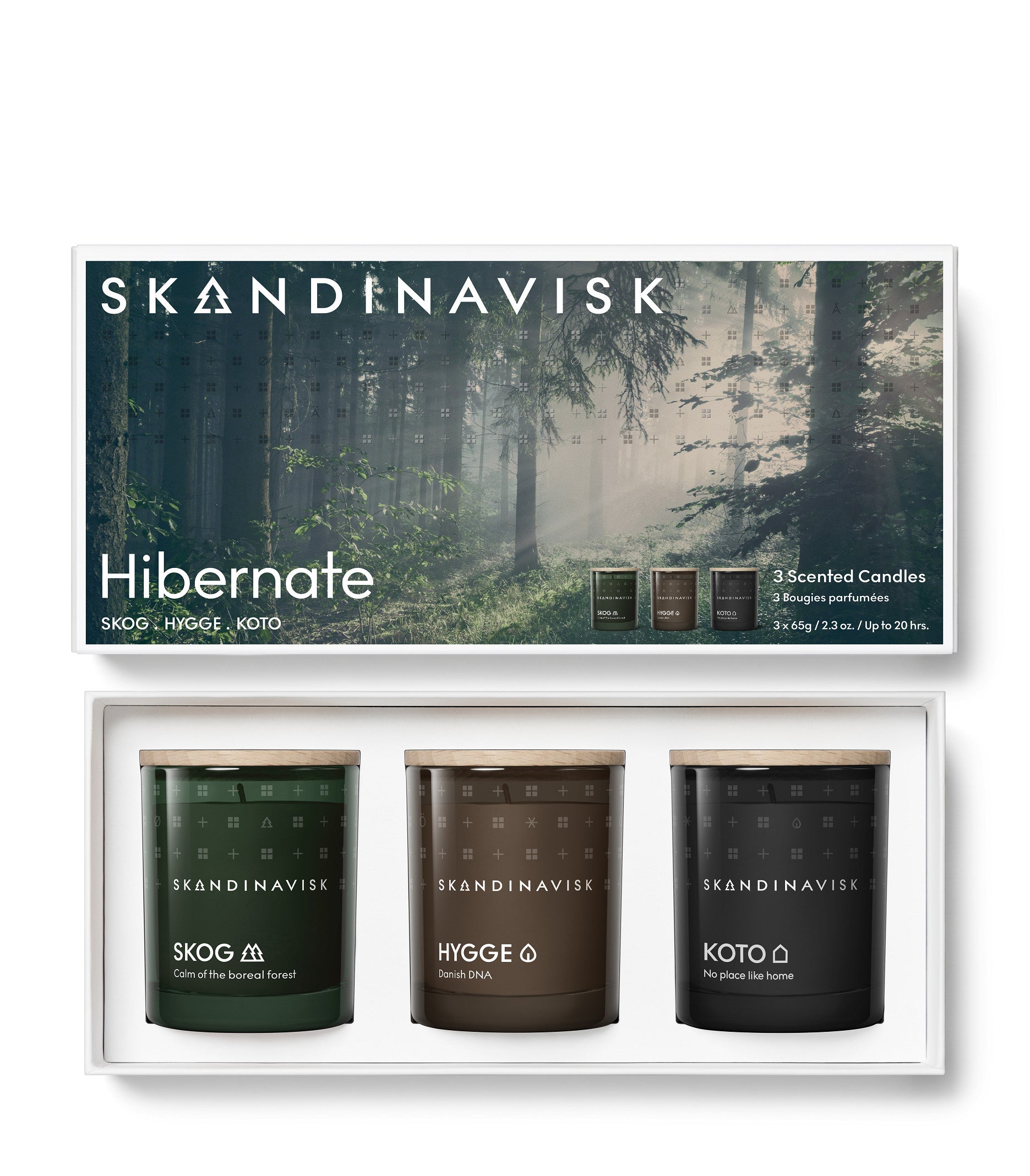 The Skandinavisk Giftset Scented Candles Hibernate includes three mini candles—Skog, Hygge, and Koto—crafted from Swedish rapeseed wax. Each candle comes in forest-themed packaging displaying the word “Hibernate” above a misty forest background.
