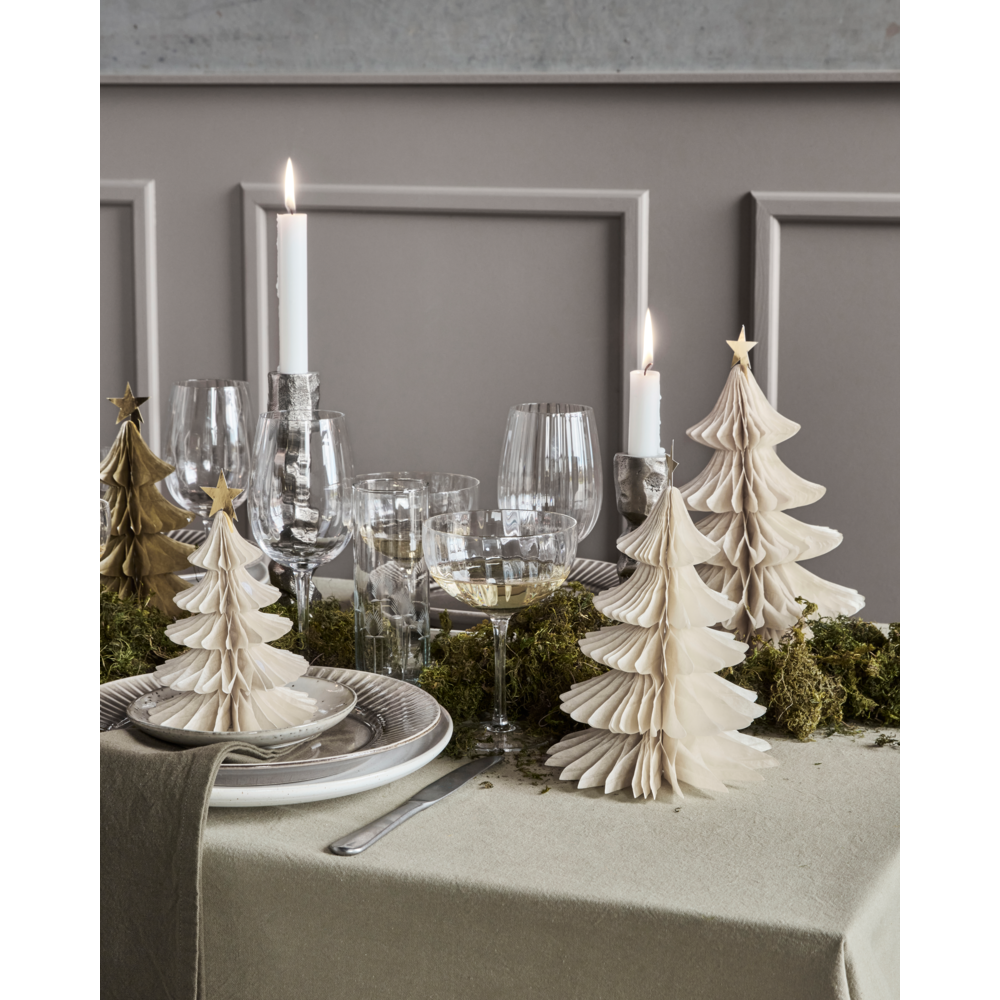 A set of three House Doctor Christmas Tree Ornament, Set of 3 in Paper, Ivory & Gold displayed as festive holiday decor on a dining table with place settings and candles.