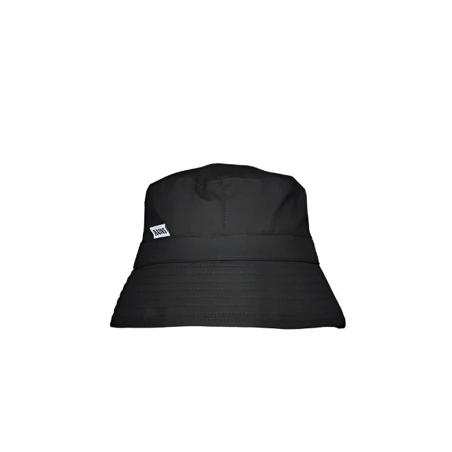 The Rains Bucket Hat in Black by Rains is a waterproof PU hat with a small white rectangular side tag, shown against a white background.