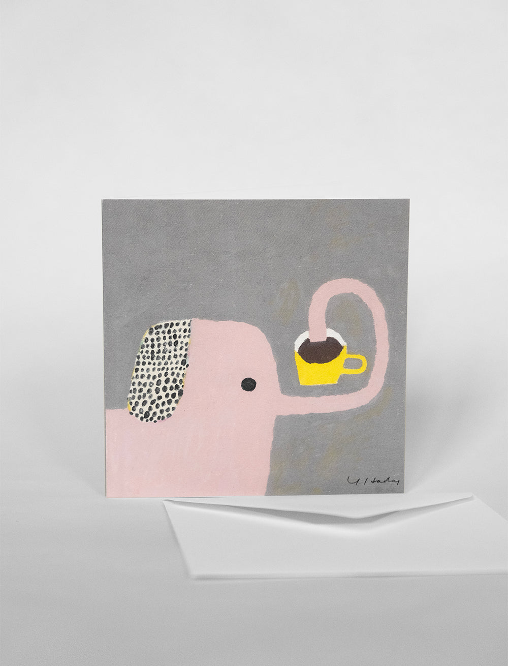 The Cest Bon Card w. Envelope by Fine Little Day features an oil pastel pink elephant with a yellow teacup on a gray background—ideal for your personalized birthday message. Includes a white envelope.
