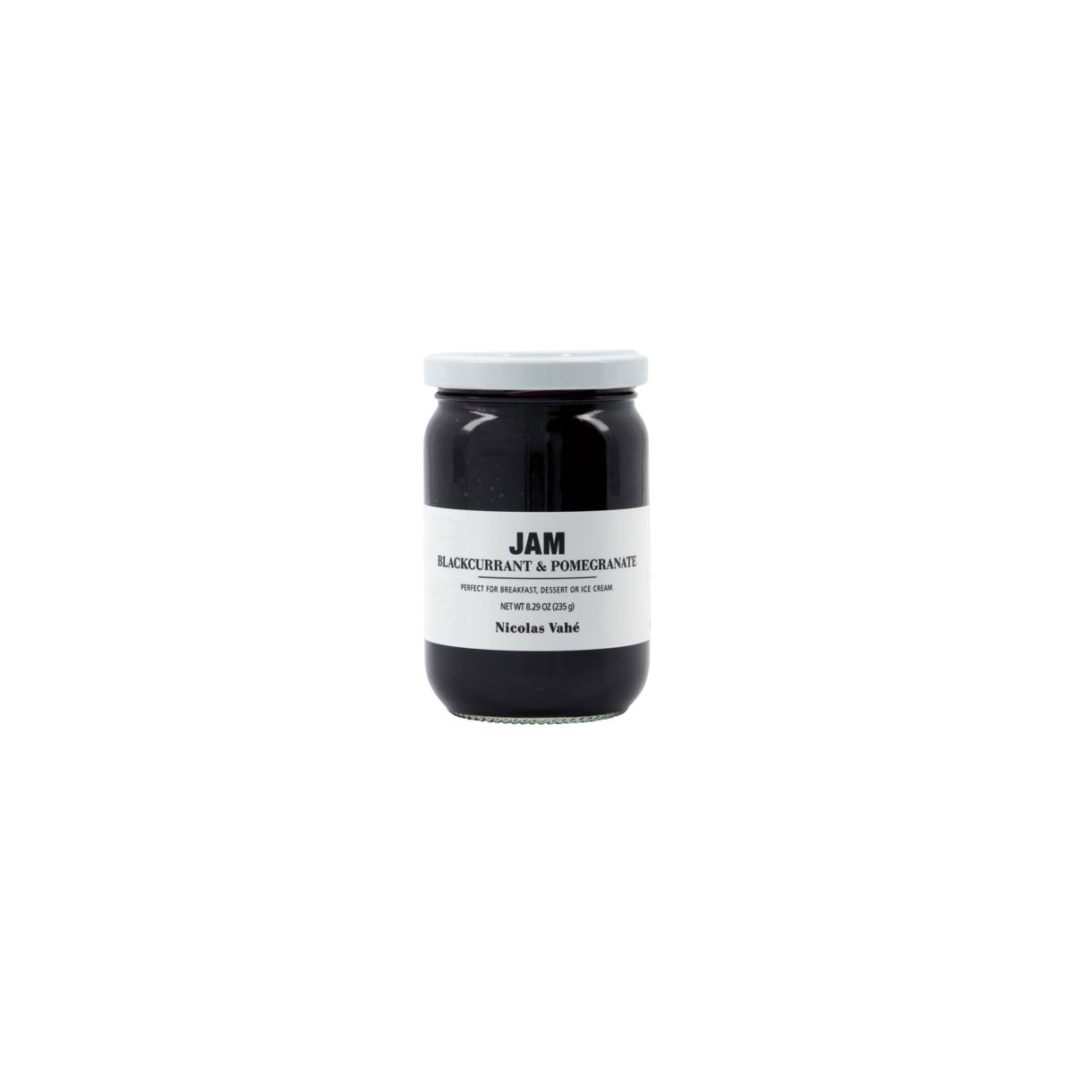 A glass jar of Nicolas Vahé Jam - Blackcurrant & Pomegranate, featuring a white lid and label, is displayed against a plain white background.