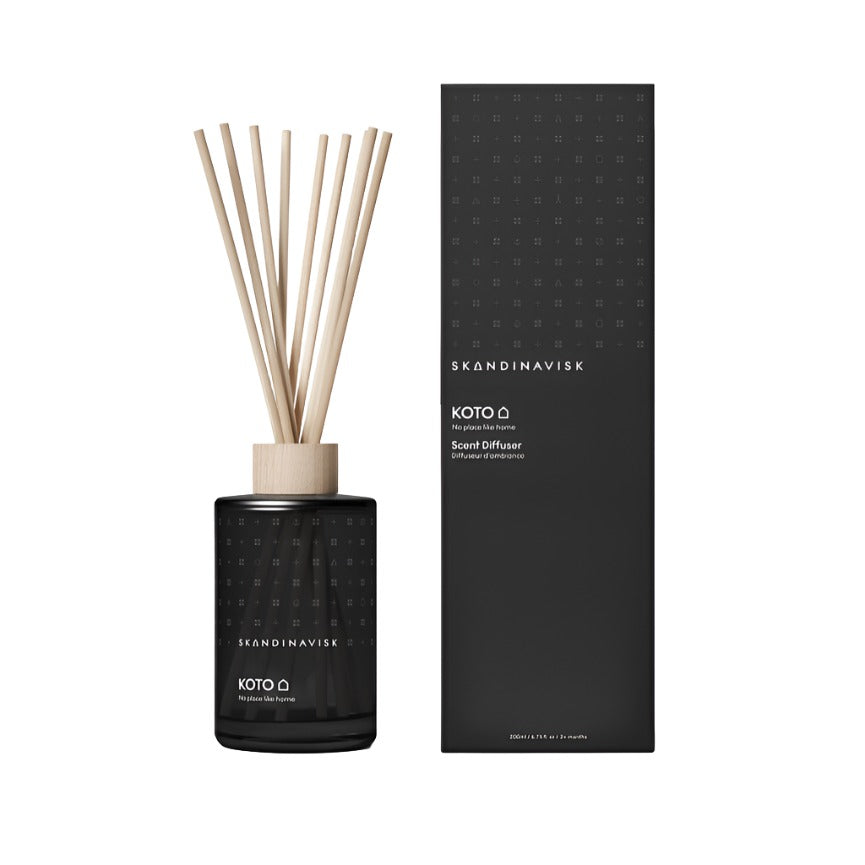 A black Scent Diffuser Koto, 200ml by Skandinavisk, with reed sticks and a matching box, offers a stylish, vegan Scandinavian room fragrance.