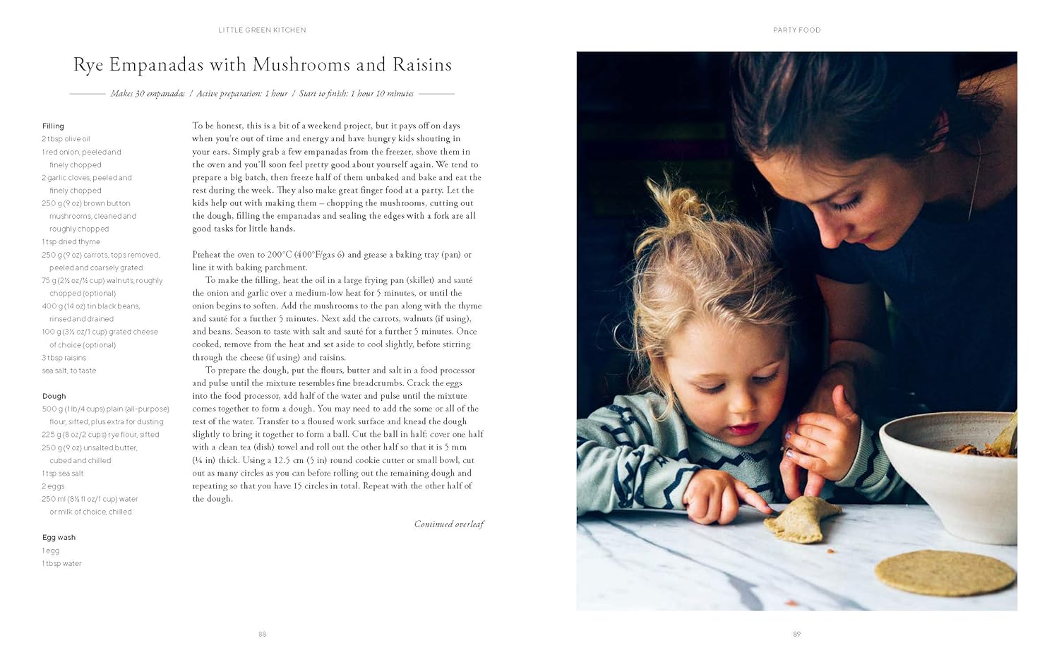 A woman and child sit at a table, filling and folding empanadas together—a heartwarming scene inspired by Little Green Kitchen - Simple Vegetarian Family Recipes from Little Green Kitchen, perfect for wholesome family meals.
