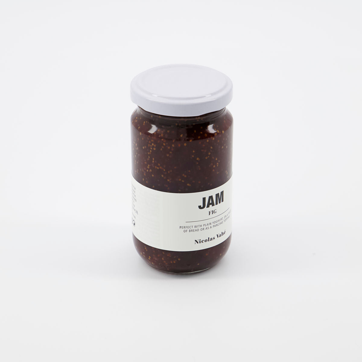 A glass jar of Nicolas Vahé Jam, Fig, featuring a minimal white label and white lid—ideal for your cheese table—set against a plain white background.