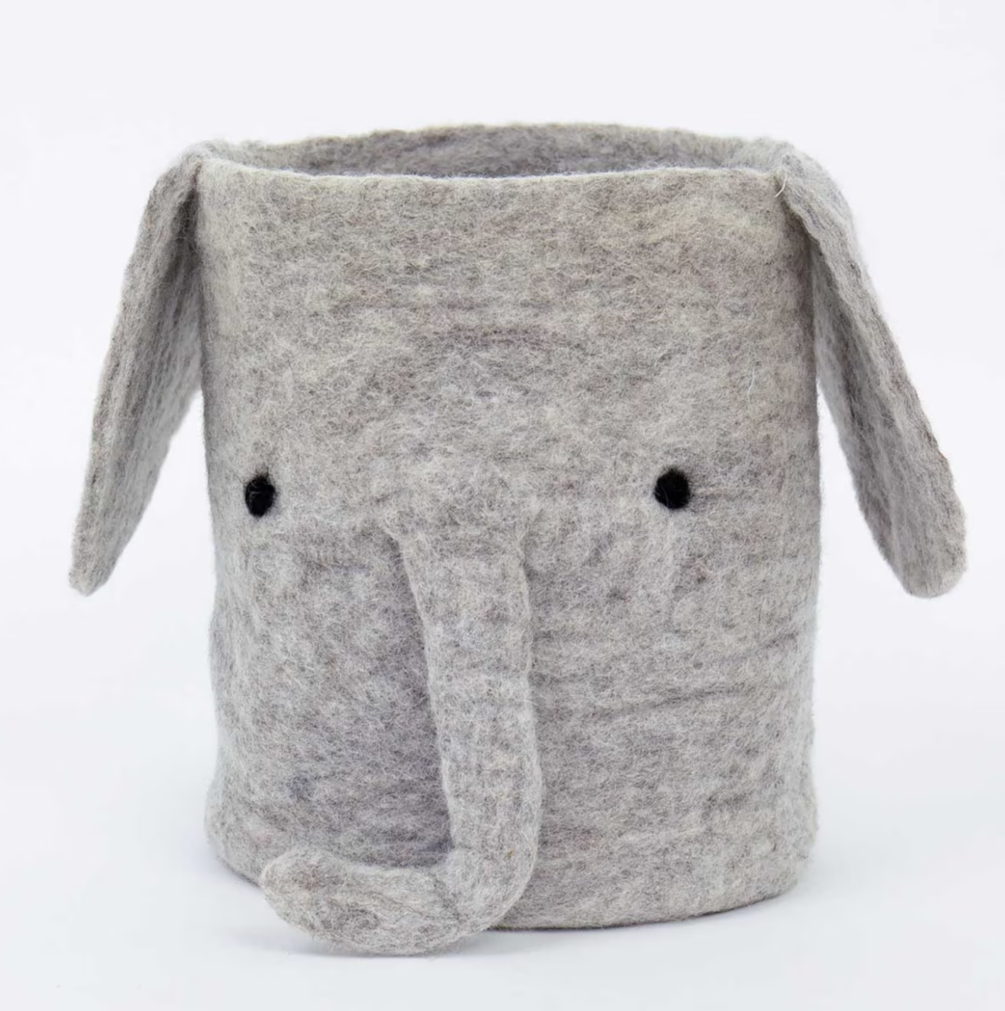 The Elephant Felt Basket by A World of Craft, featuring floppy ears, a trunk, and black eyes, is a handmade gray wool storage basket that adds playful charm to any room. It sits against a plain white background.