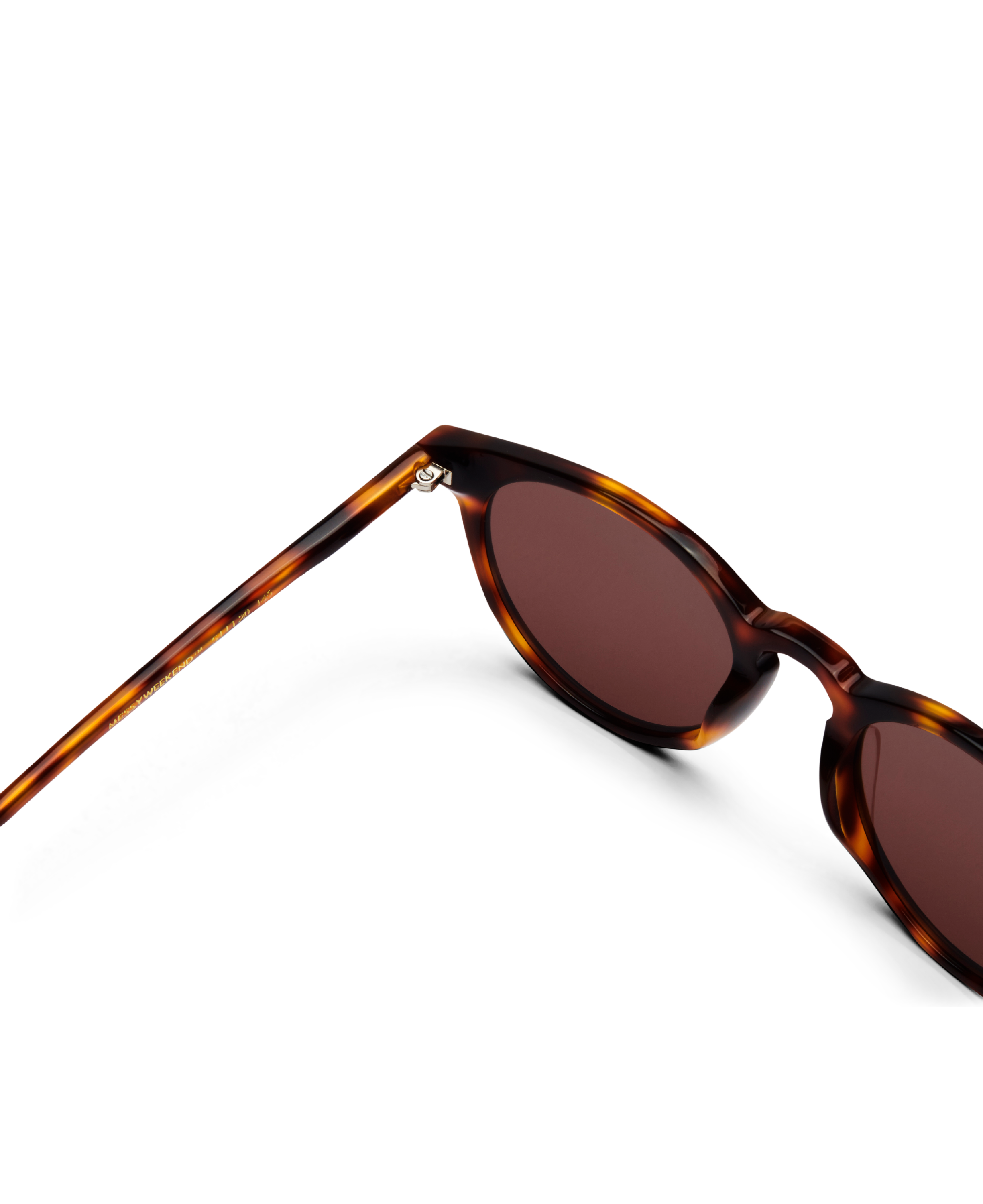 A close-up of MESSYWEEKEND Sunglasses New Depp in Tortoise Brown with brown lenses, featuring acetate frames, displayed against a black background.
