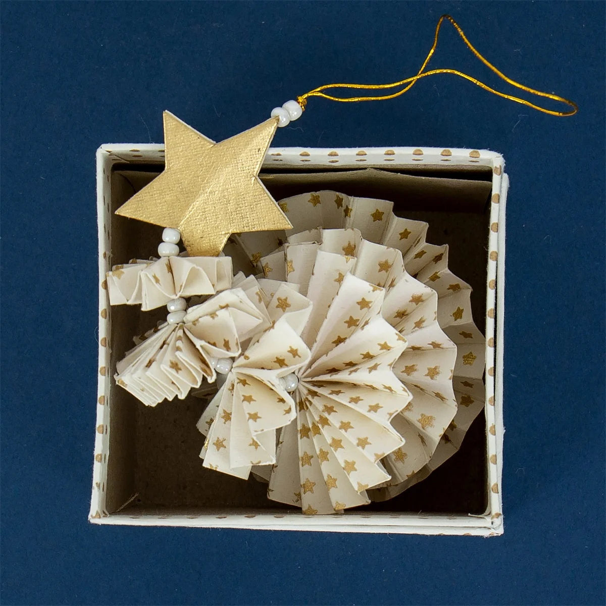 The Fold Fir Tree Christmas Ornament in white & gold by A World of Craft is a handmade, eco-friendly paper decoration with gold stars and white beads, beautifully boxed with a starry design—perfect for your elegant festive décor.