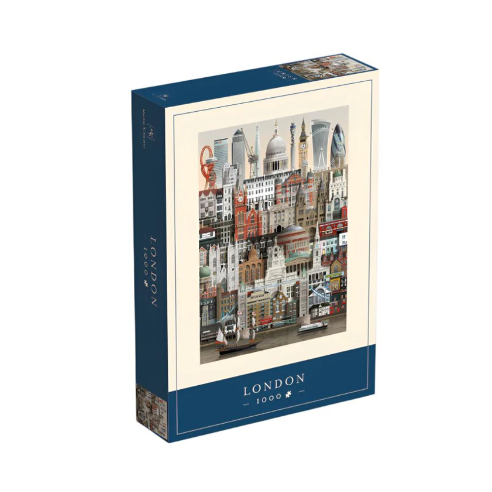 The Martin Schwartz London City Puzzle features 1,000 pieces with illustrated London landmarks—Big Ben, St Paul’s Cathedral & the London Eye—in a stylish collage on a cream background with a blue border.
