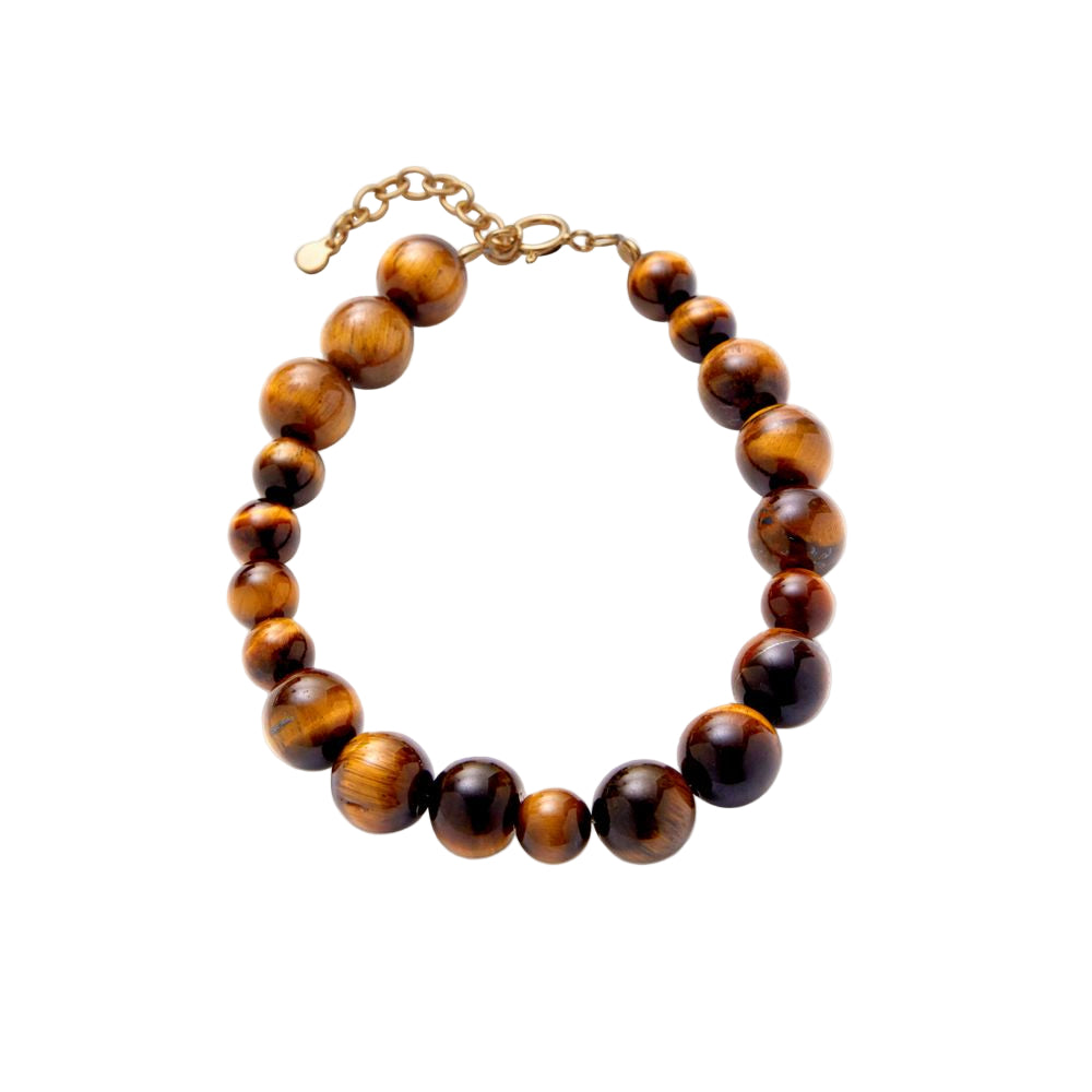 The Pernille Corydon Earth Bracelet with Tiger Eye Stones features polished, glossy beads in warm striped tones—arranged from small to large—and finished with a gold adjustable chain and clasp.