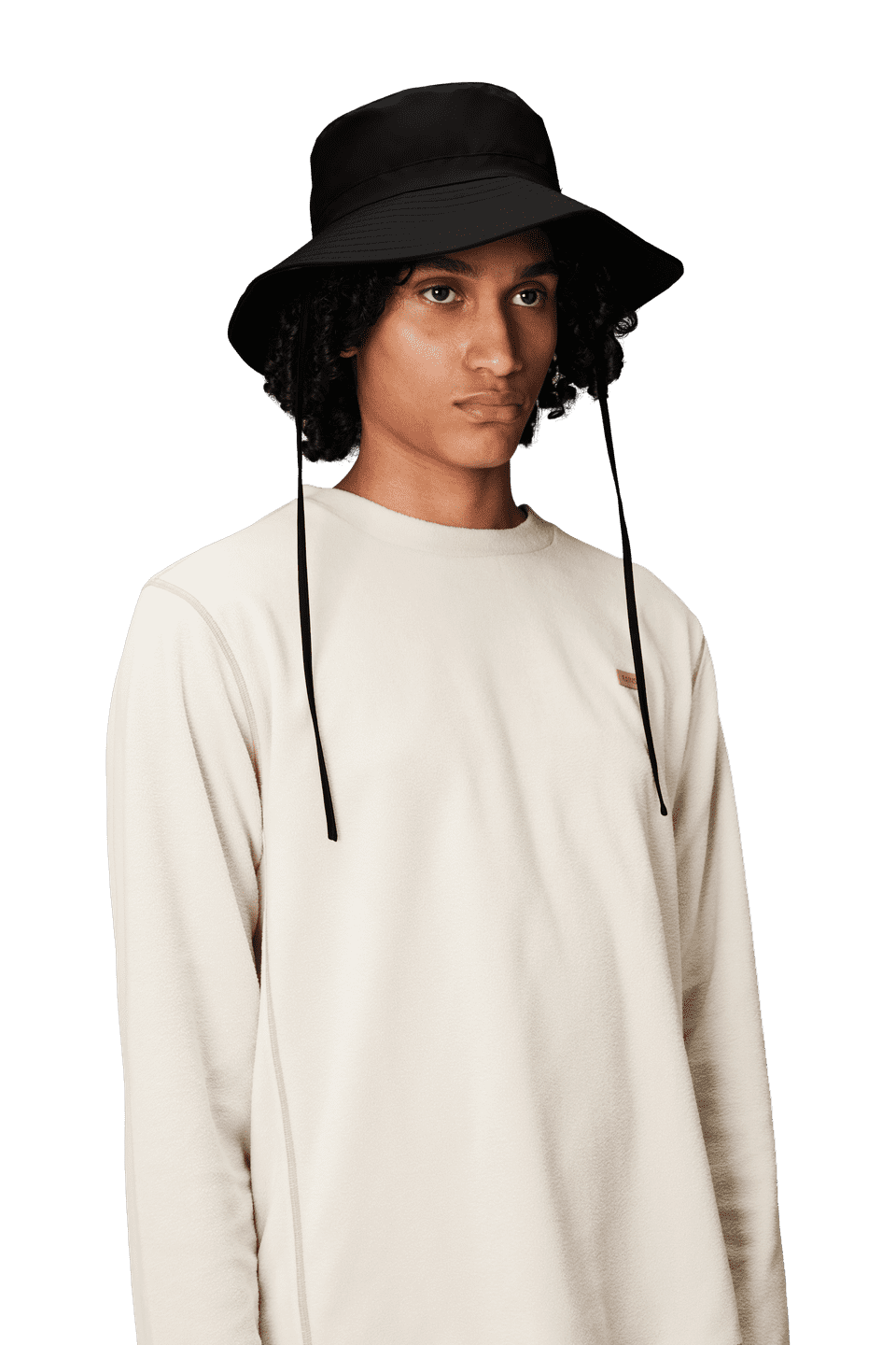 A person wears the Rains Boonie Hat in Black by Rains, featuring chin straps and durable PU fabric, paired with a light beige long-sleeve shirt against a plain background—ideal rainwear for outdoor adventures.