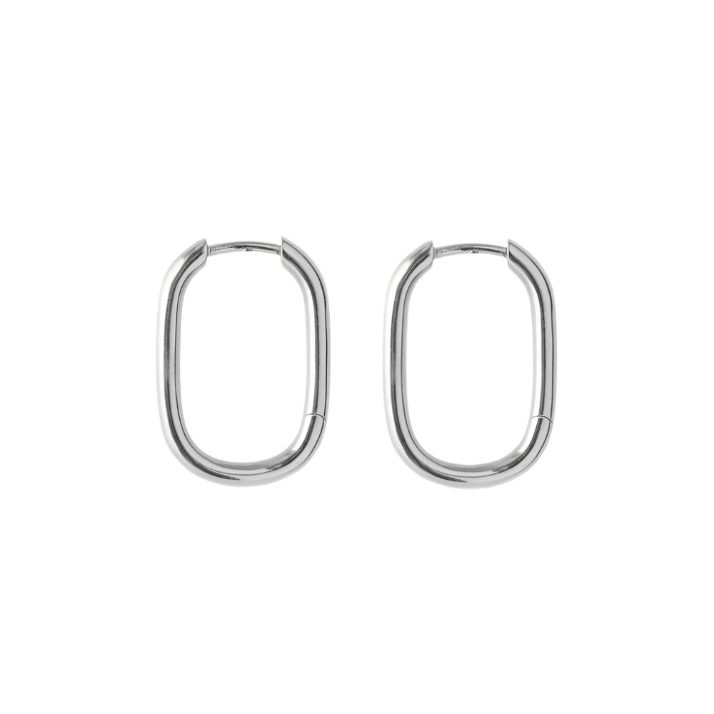 The Soft Edge Huggies in Silver by Pernille Corydon are minimalist, oval-shaped hoop earrings shown against a plain white background.