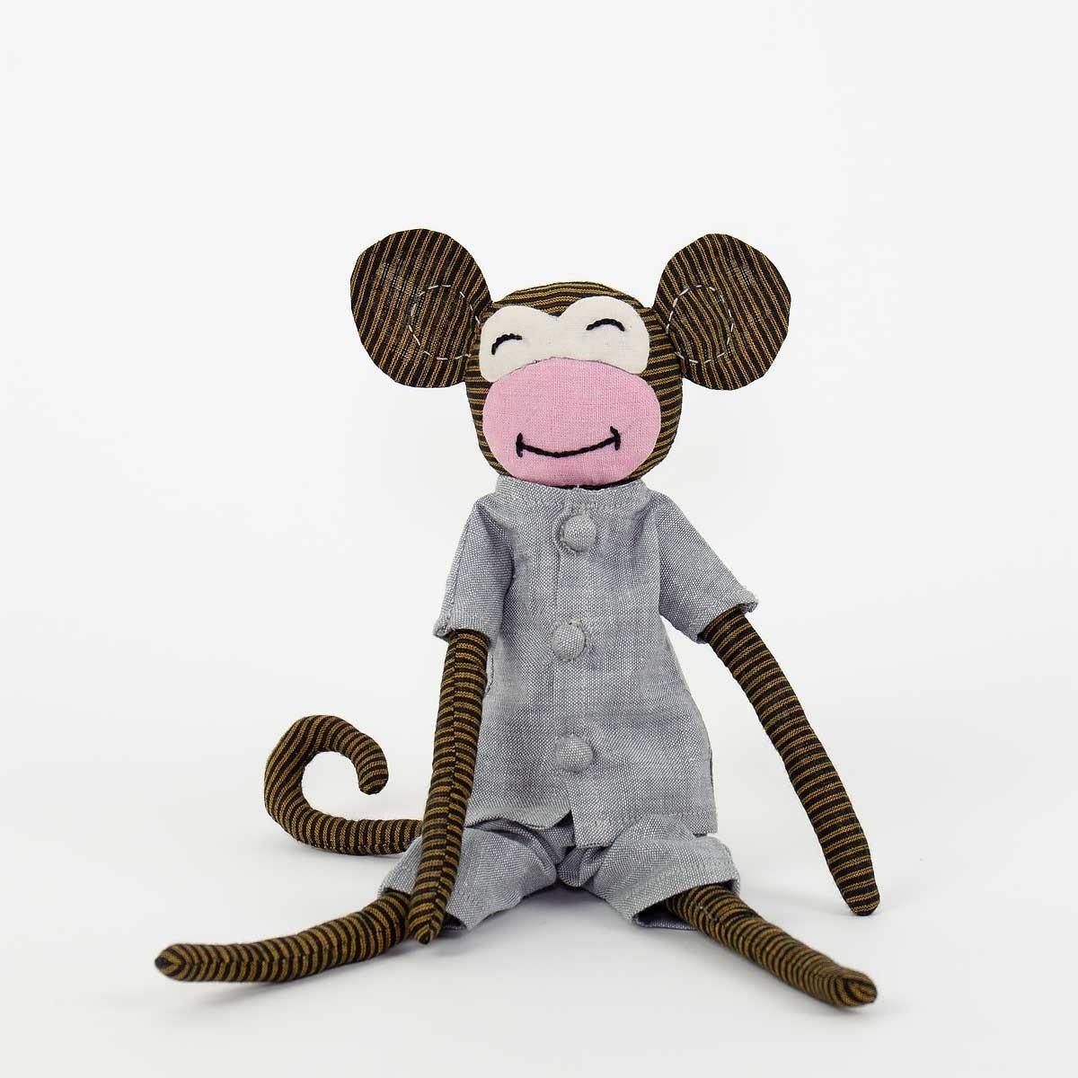 The Molle Monkey Soft Toy by A World of Craft features striped brown fur, a pink face, and a grey buttoned outfit. Filled with hypoallergenic eco-friendly kapok, it sits upright against a plain white background.