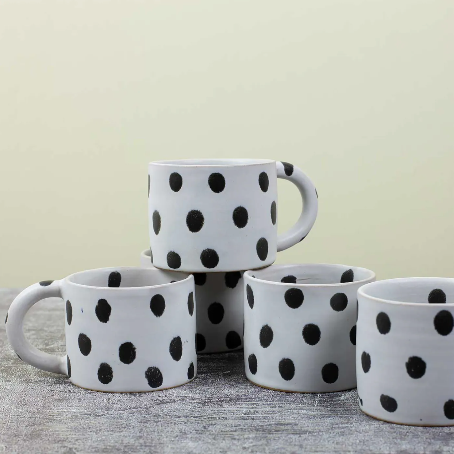 Five A World of Craft Blot Coffee Mugs in black & grey are arranged on a grey surface against a light background, with one mug stacked on top of the others.