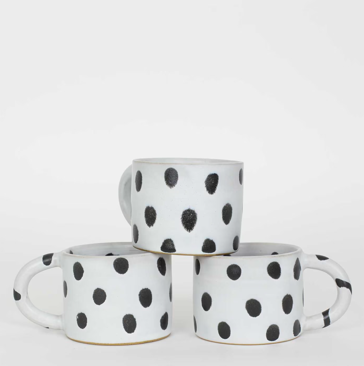 Three A World of Craft Blot Coffee Mugs in black & grey are stacked in a pyramid arrangement against a plain white background.
