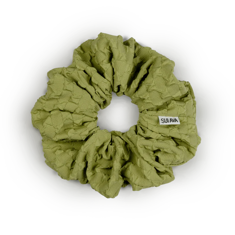 The Daydream Scrunchie in Lime Green by Sui Ava is a large, textured hair accessory featuring a small white Sui Ava label—an effortlessly stylish addition to any look.