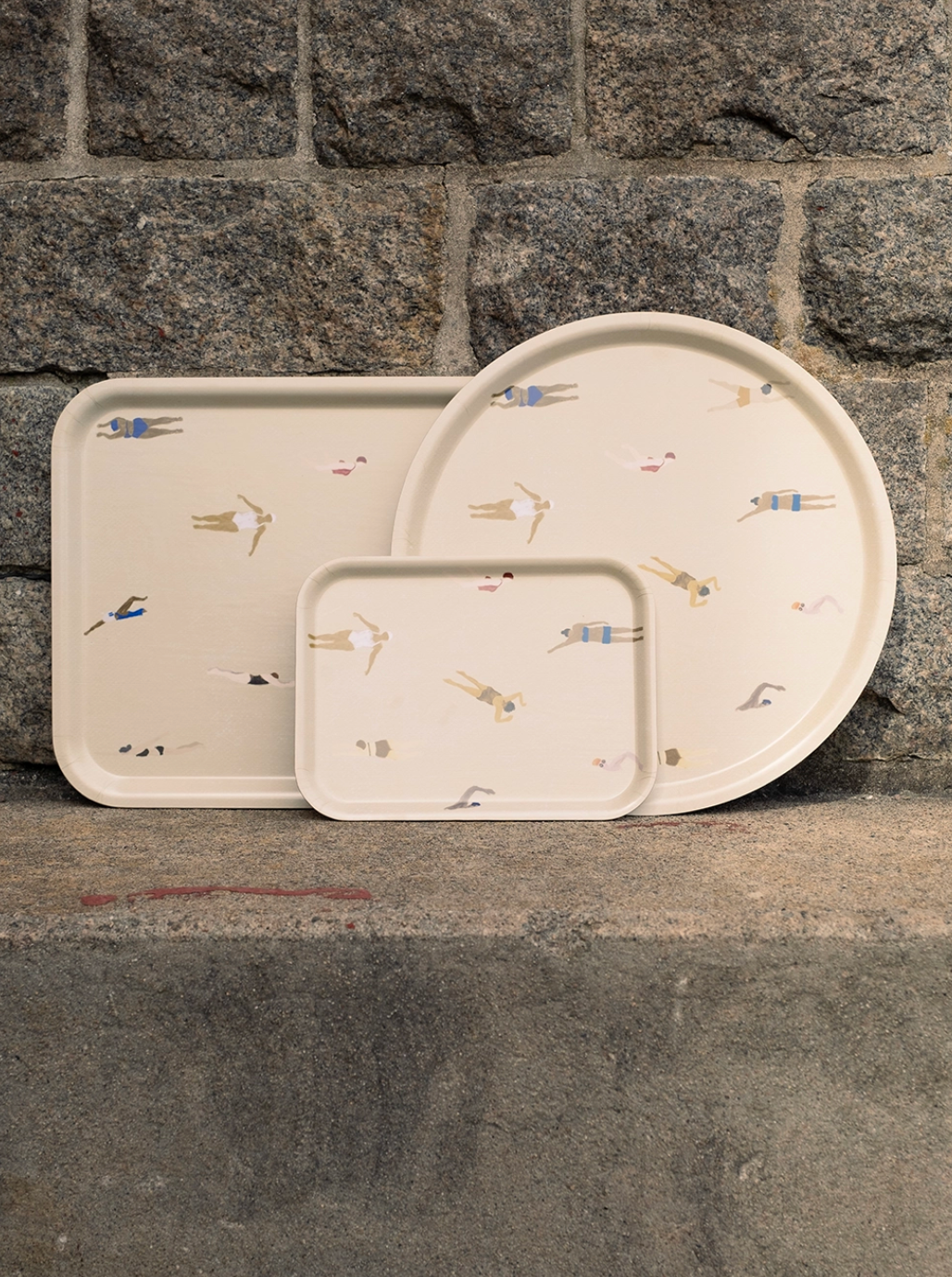 Swimmers Tray Small in sand, laminated birch wood, perfect for herbs or sandwiches, featuring hand-drawn swimmer designs.