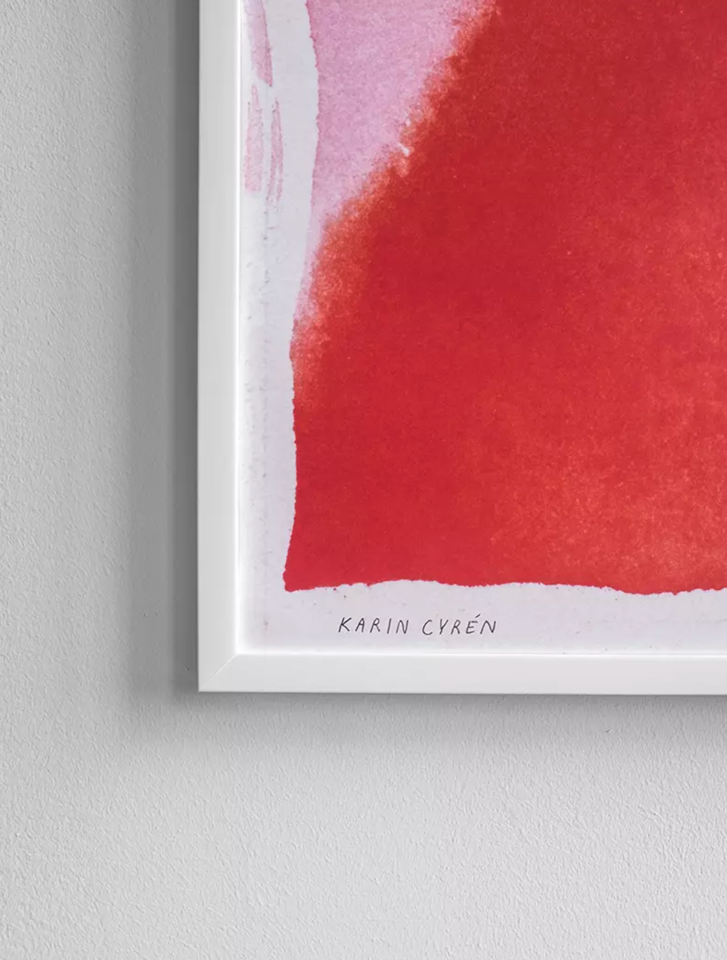 Close-up of the Sun Print poster (70x70 cm) by Fine Little Day—an abstract red and pink watercolor wall art piece, with artist Karin Cyrén’s name at the bottom. A vibrant artwork from Stockholm’s acclaimed illustrator.