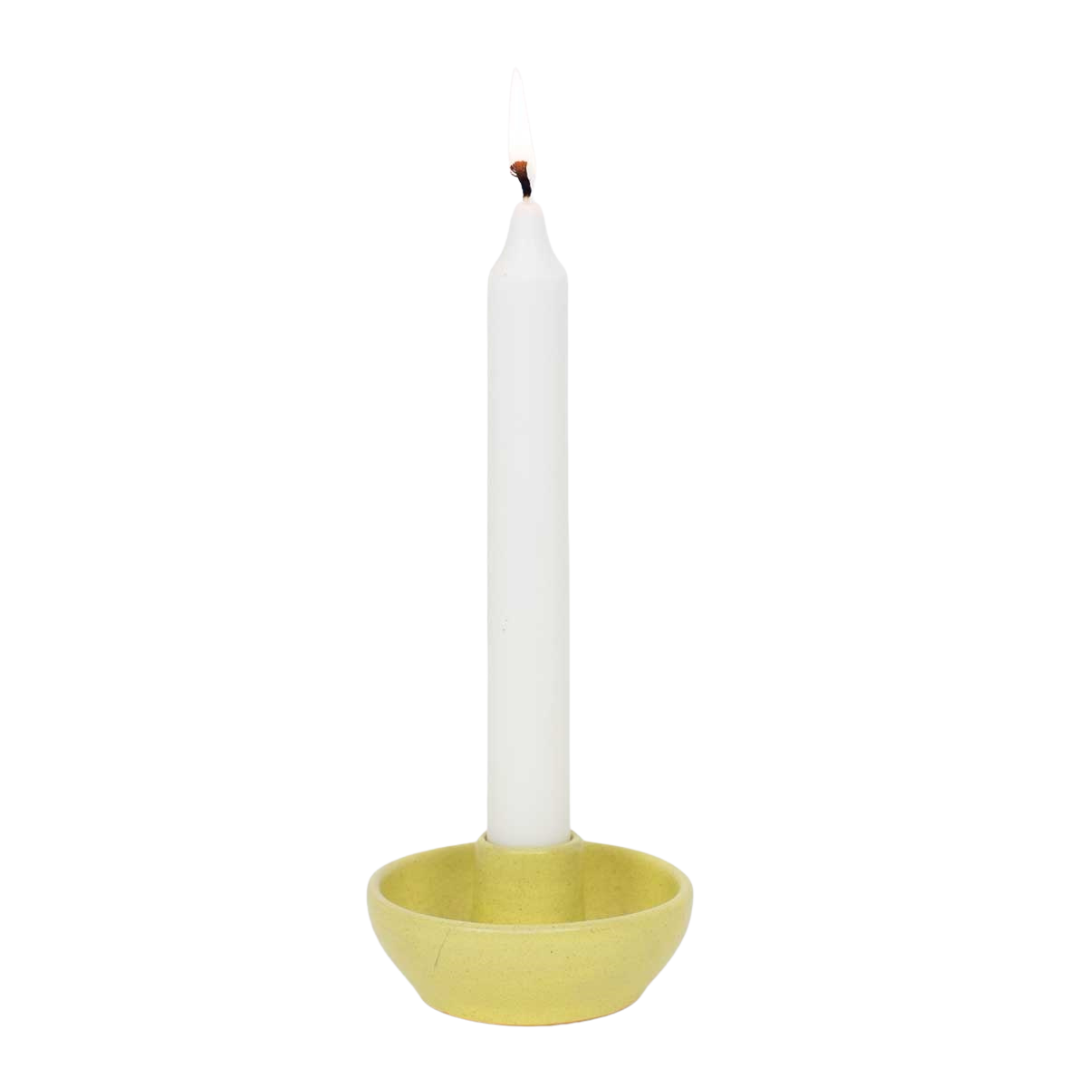 A lit white taper candle stands upright in the Selma Handmade Candle Holder by A World of Craft, featuring a simple round yellow stoneware design, set against a plain white background.