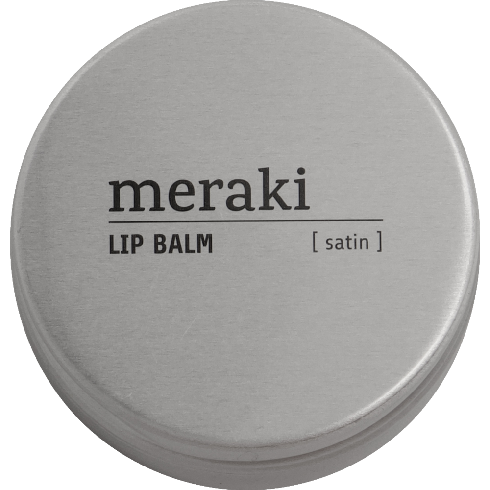 A round, silver tin labeled Meraki Organic Lip Balm, Satin is shown from above against a light background. This moisturising lip balm is made with natural oils.