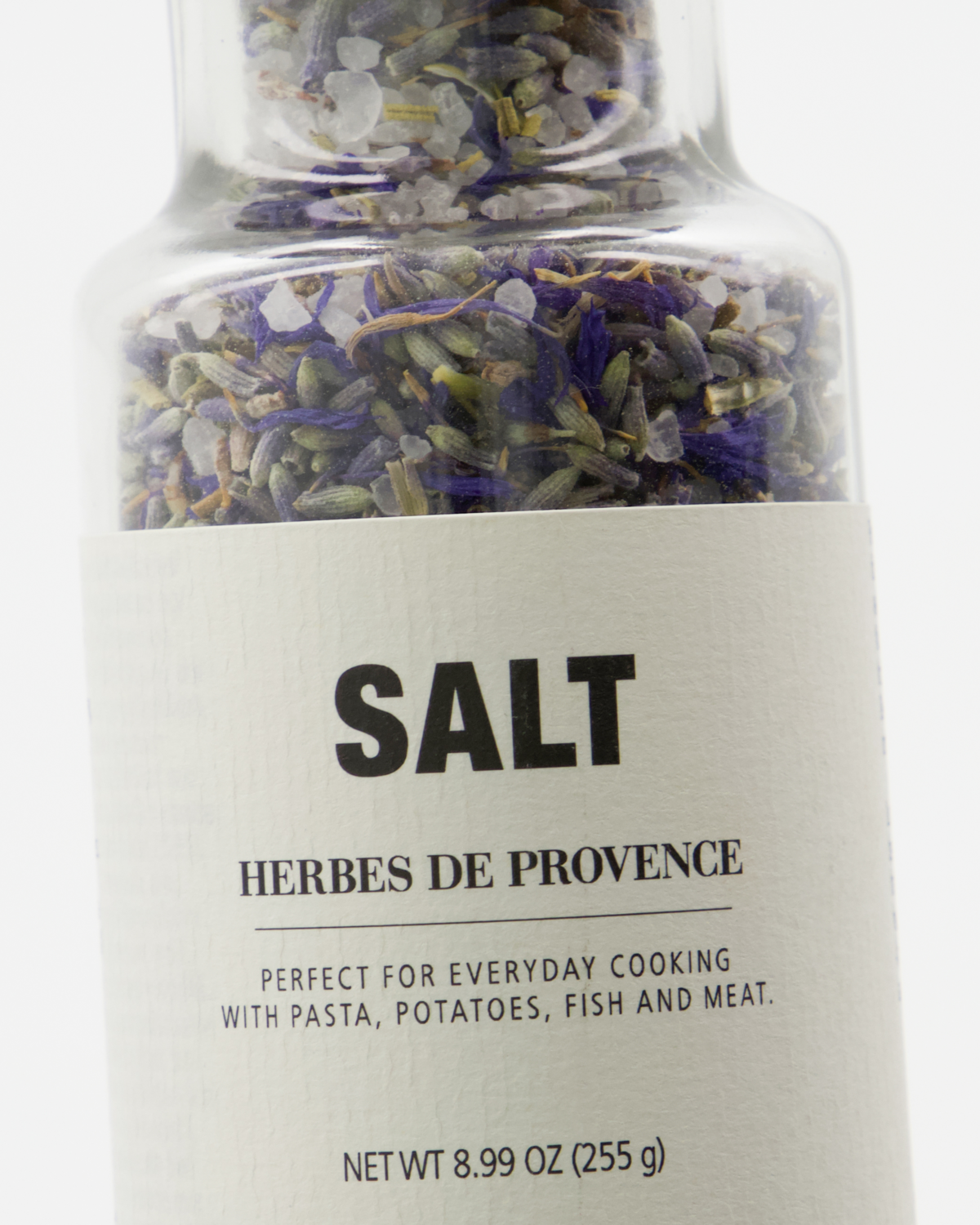A close-up of a Nicolas Vahé Salt, Herbes de Provence jar, featuring sea salt and dried herbs. Ideal for pasta, potatoes, fish, or meat. Net weight: 8.99 oz (255 g).