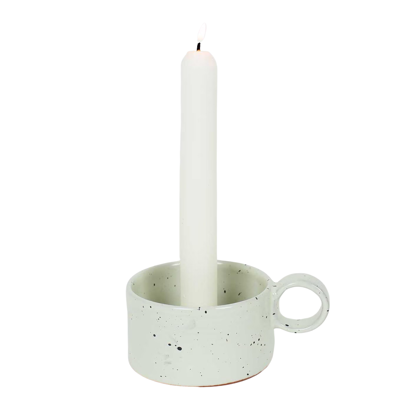 A lit tall white candle rests in the "Candle Holder with Ear, Earth, Handmade" by A World of Craft—a speckled light gray stoneware holder with a circular handle—set against a plain white background.