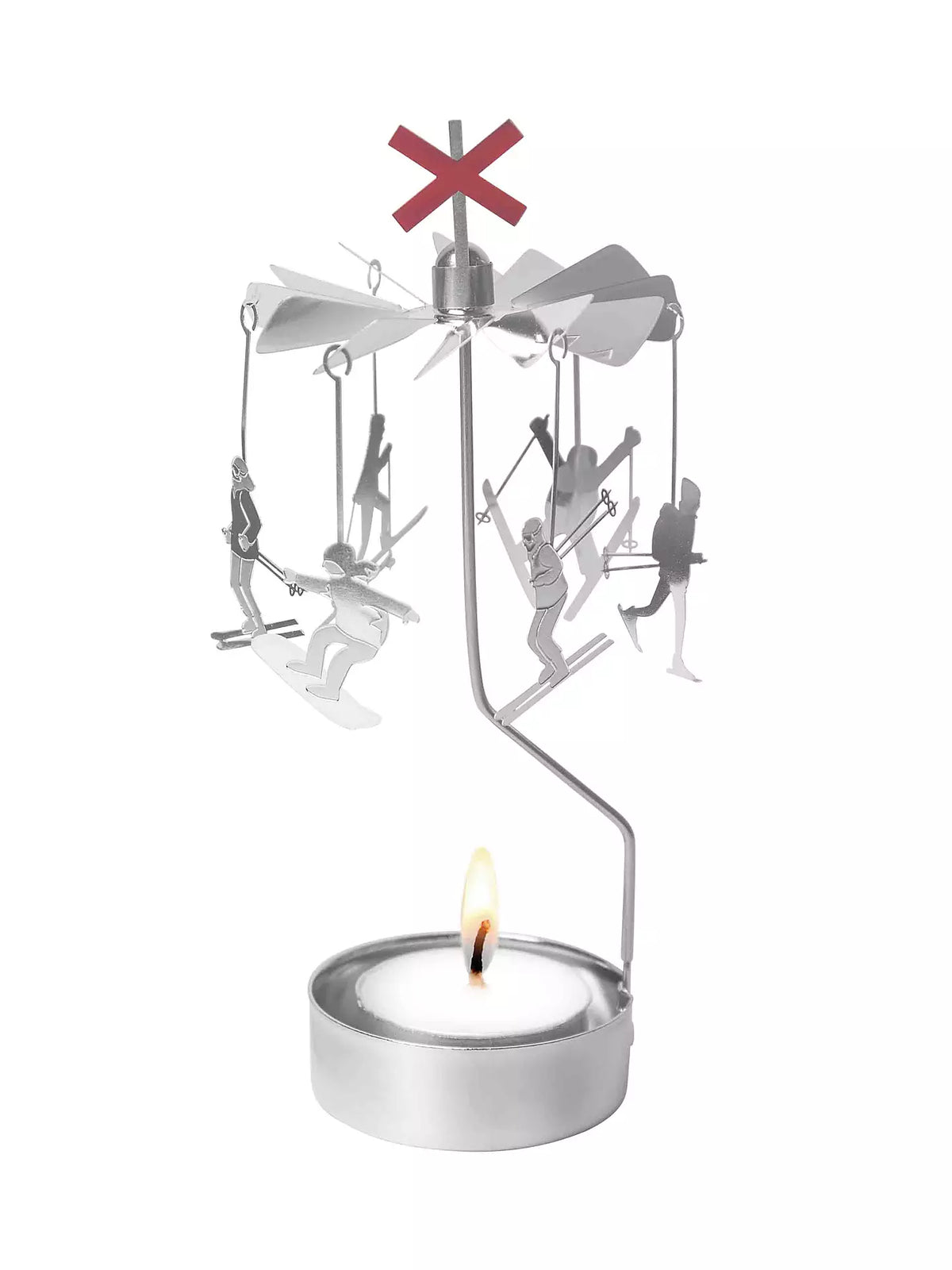 The Tealight Spinner, Up North in Silver by Pluto Design Sweden features miniature skiers and snowboarders rotating gracefully above a lit tealight, topped with a red X, adding a charming decorative touch that enhances any tranquil atmosphere.