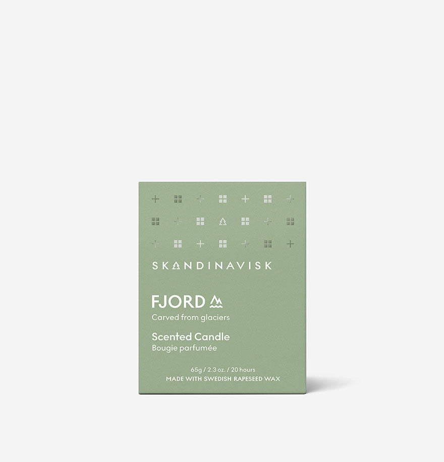 A green box labeled “Skandinavisk Mini Scented Candle Fjord 20h, 65g,” made with Swedish rapeseed wax and an engraved beechwood lid, is shown against a plain white background.