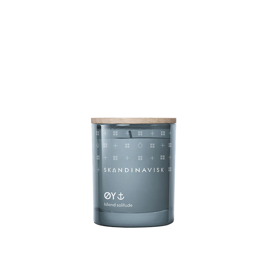 The Mini Scented Candle Oy 20h, 65g by Skandinavisk features blue glass, a Swedish rapeseed wax blend, and an engraved beechwood lid, shown on a plain white background.