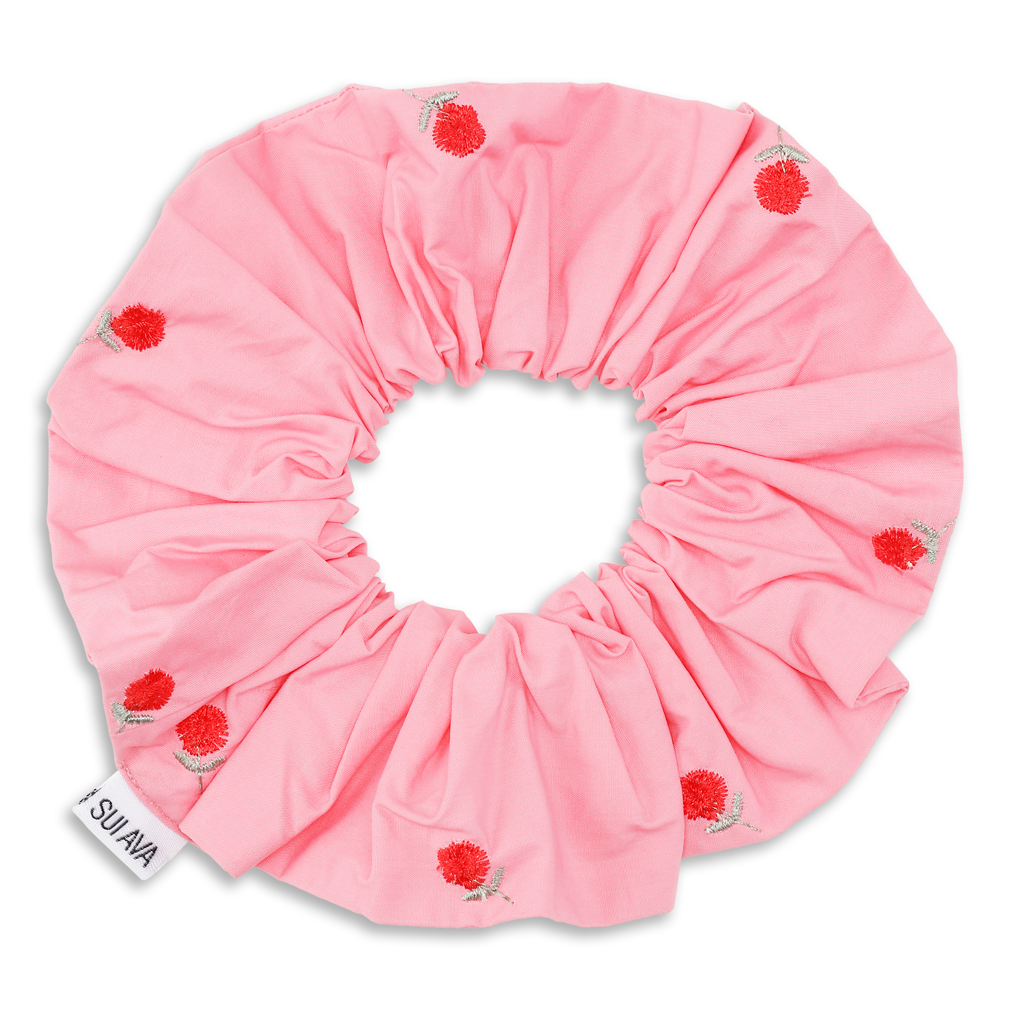 The Sui Ava Bobbie Scrunchie in Rose Pink is a large, gentle hold accessory with pink fabric, embroidered red flowers and green stems, finished with a white SUJAA tag on the edge.