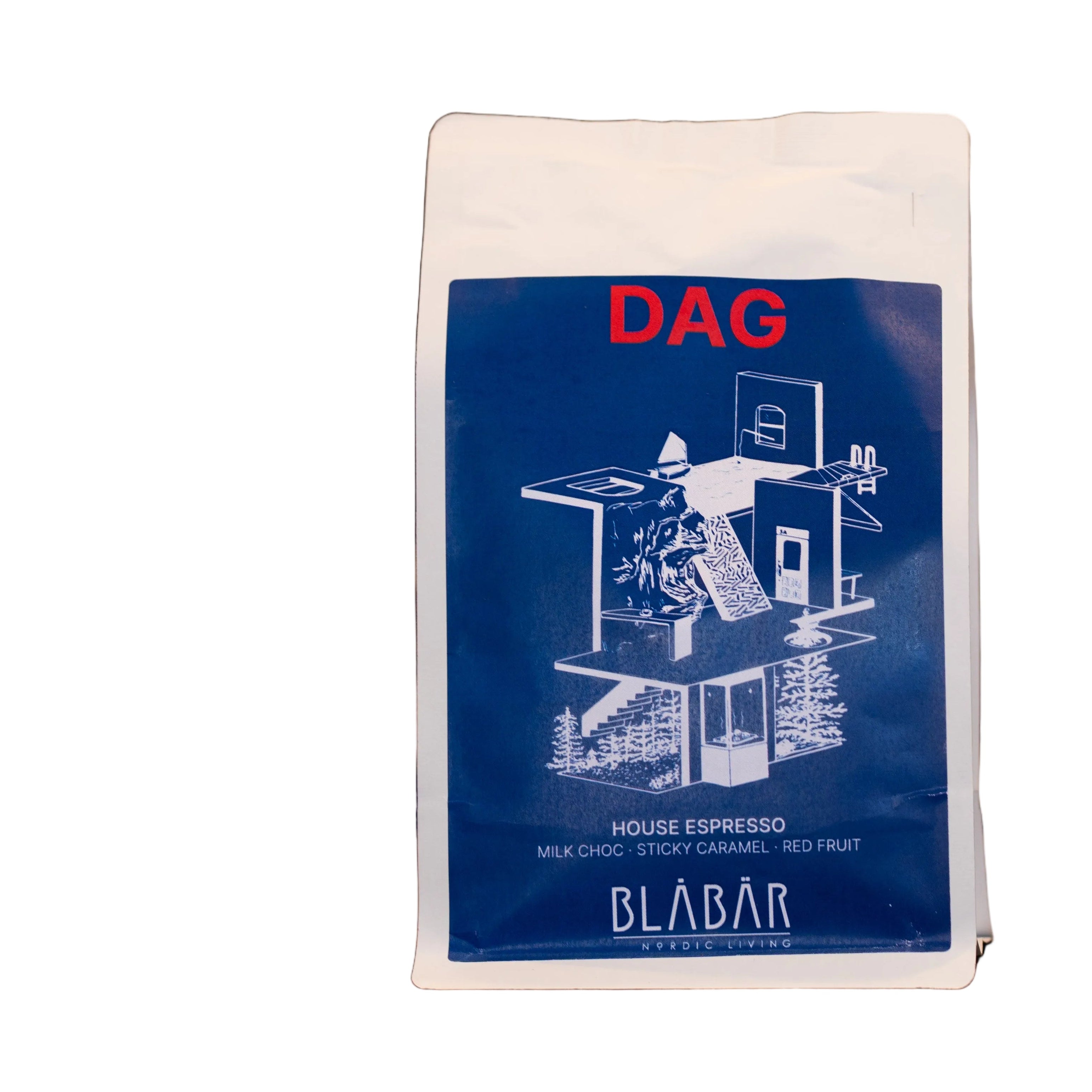 A white coffee bag labeled “DAG” with a blue panel featuring a line drawing of a house contains DAG House Coffee Beans Blåbär, Single Origin Colombia (250g) by Blåbär Nordic Living, described as a house espresso—perfect for your morning flat white—with notes of milk chocolate, sticky caramel, and red fruit.