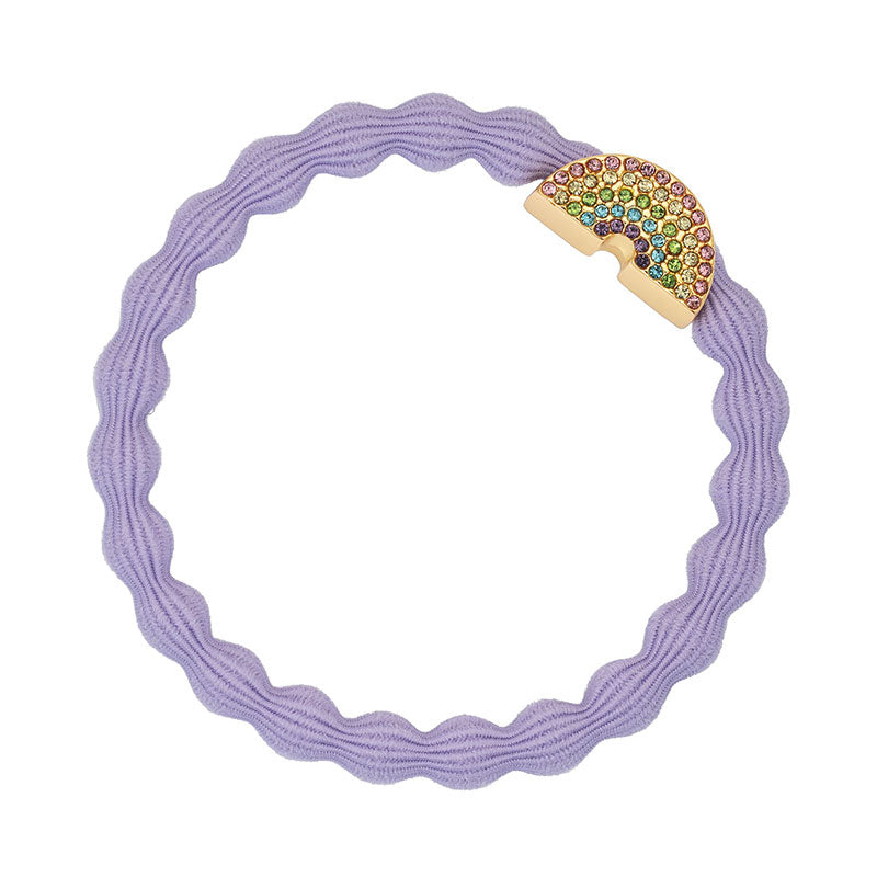 The ByEloise Bangle Band Bling Rainbow in Lavender is a wavy hair tie featuring a rose gold rainbow charm encrusted with colorful rhinestones—a stylish rainbow accessory.