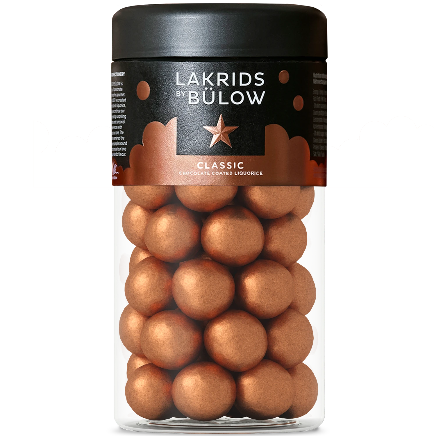 A clear jar with a black lid contains shiny bronze-coated round candies. The label reads Lakrids by Bülow Classic Caramel Liquorice, hinting at this winter classic treat—where rich liquorice chocolate meets the delicate crunch of sea salt flakes.