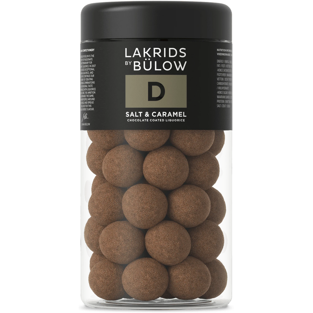 A clear jar with a black lid contains round, chocolate-coated liquorice balls. The label displays Lakrids by Bülow Salt & Caramel Liqourice, Regular, D—featuring sweet and salted caramel liquorice enrobed in decadent dulce chocolate.