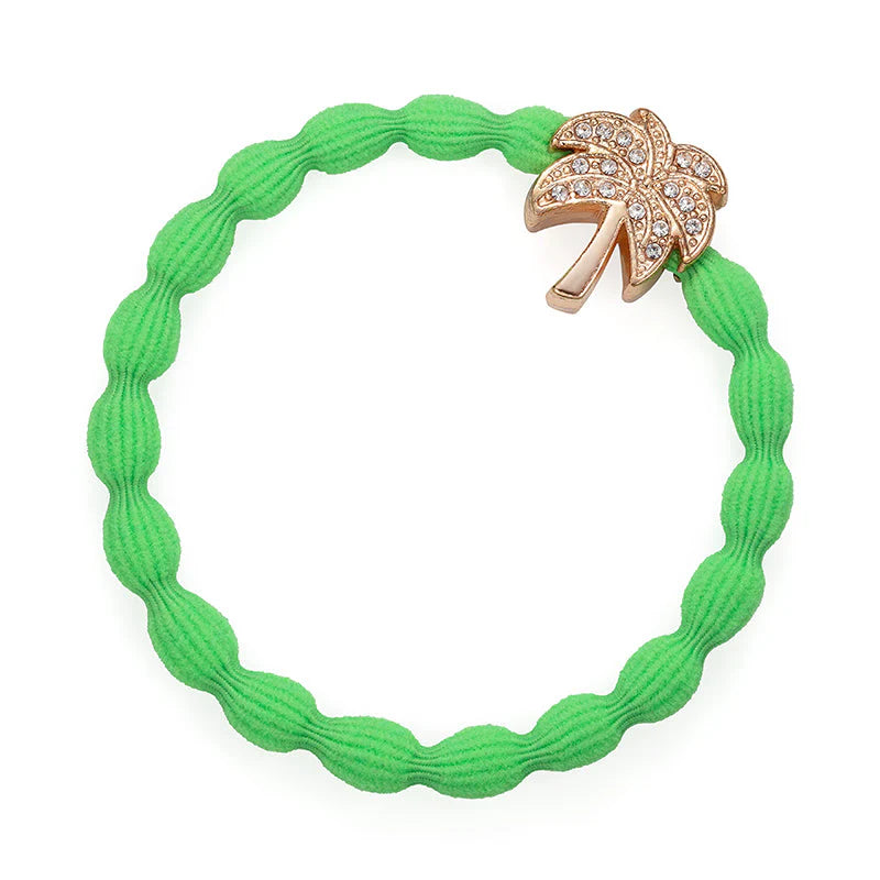 The Bangle Band in Neon Green, Palm Tree by ByEloise is a wavy elastic bubble hairband featuring a gold palm tree charm adorned with small rhinestones. This snag-free accessory combines stylish flair and everyday comfort.