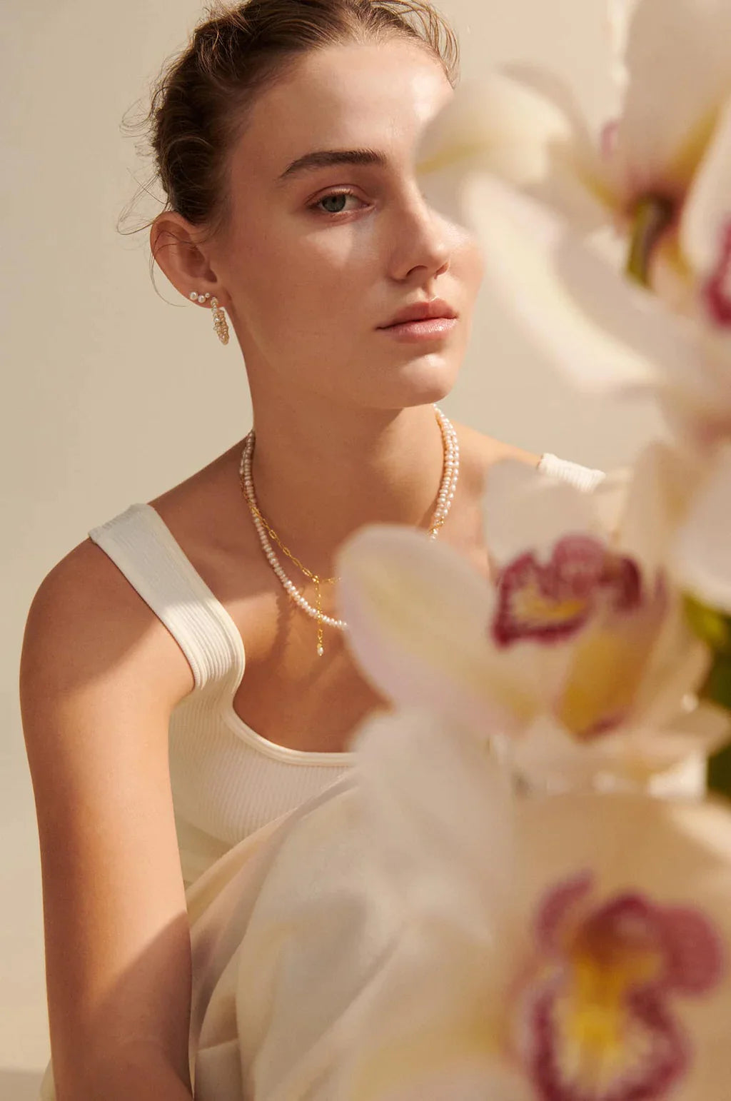 Woman with brown hair wearing Pernille Corydon Liberty silver necklace