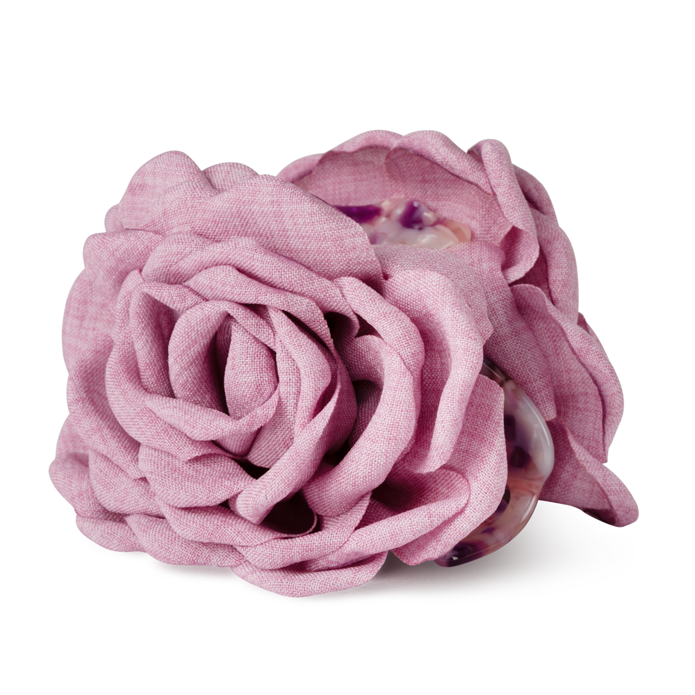 The Sui Ava Hair Claw Rosa in Pink Rose features a large, layered fabric flower accessory on a strong-grip hair claw, displayed against a plain white background.