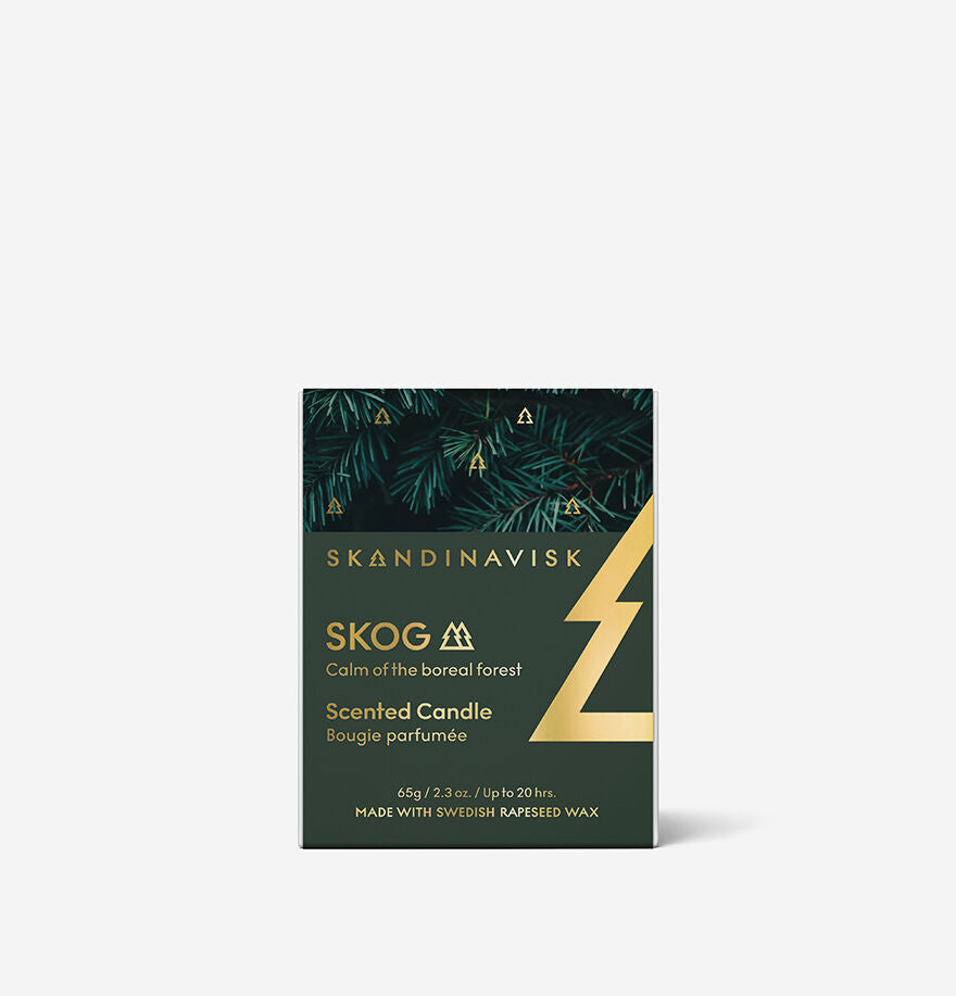 The Skandinavisk Seasonal Skog Gold Scented Candle 20h, 65g features forest graphics and gold text, is made with Swedish rapeseed wax, and provides up to 20 hours of fragrance.