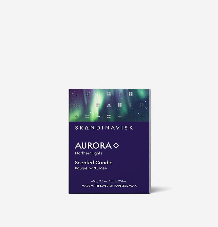 Boxed Skandinavisk Seasonal Aurora Scented Candle 20h, 65g, made from Swedish rapeseed wax with a green and purple aurora design and product details displayed on a white background.