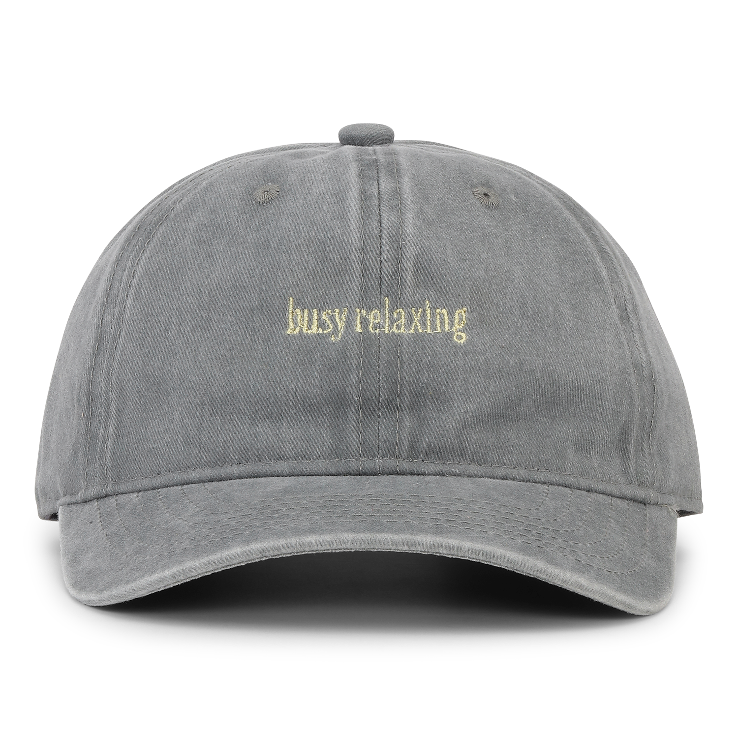 The Sui Ava Soft Served Cap, Busy Relaxing in Liquorice Grey, features "busy relaxing" embroidered in small yellowish-white letters on the front and has an adjustable closure for a comfortable fit.