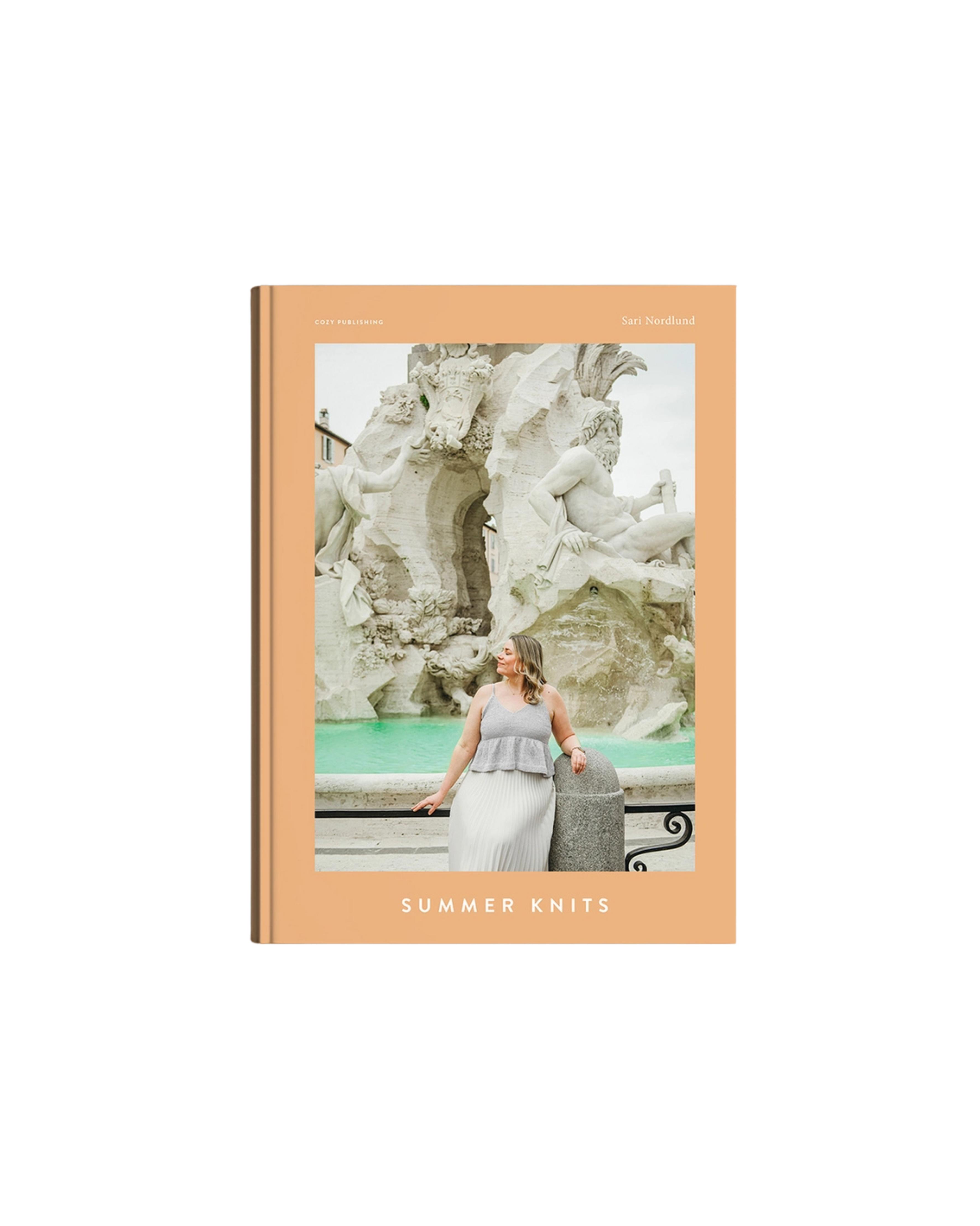 The Summer Knits Book by Cozy Publishing features summer knit patterns by Sari Nordlund. Its cover shows a woman in a sleeveless knit top and skirt before a marble fountain, framed by a peach border and minimalist design.
