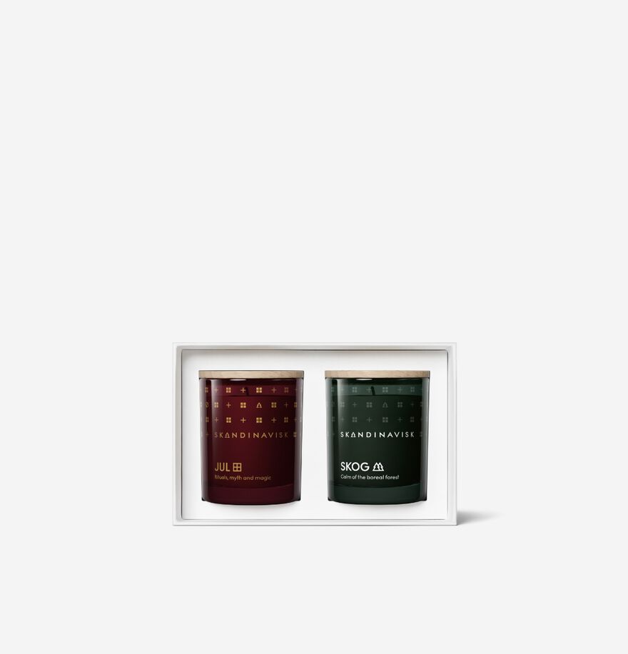 Giftset Yuletide by Skandinavisk: two mini scented candles—JUL (dark red) and SKOG (dark green)—in a boxed set, displayed on a plain white background. The perfect seasonal duo.