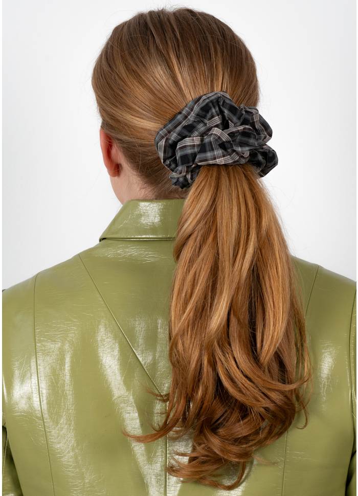A person wearing a brown and grey Tartan Scrunchie in Brown & Grey in a ponytail.