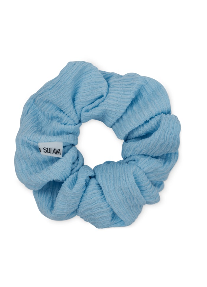 Sui Ava Ea Zig-Zag Scrunchie in sky blue, featuring a textured surface and a small white brand tag.