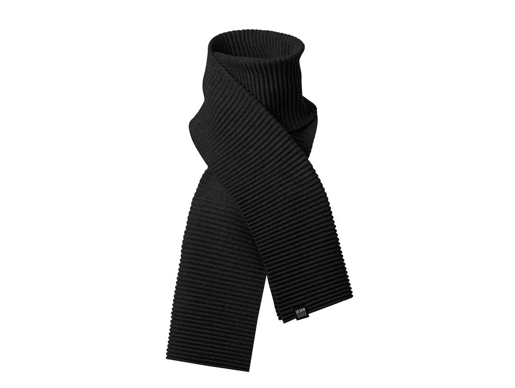 The Pleece Scarf Long in Black from Design House Stockholm, featuring a ribbed knit design, is neatly crossed and displayed on a white background.
